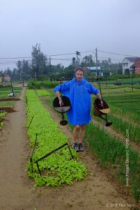 Watering the vegetables, Vietnam style.