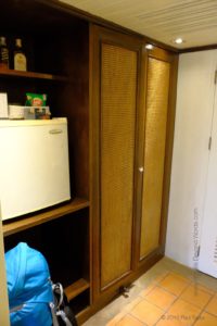 A lobby with the fridge and wardrobe